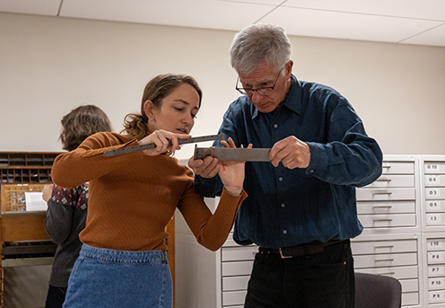 Cecelia Ramsey works with David Sellers during a bookmaking course in Special Collections.  Photo credit: Brandon Johnson.