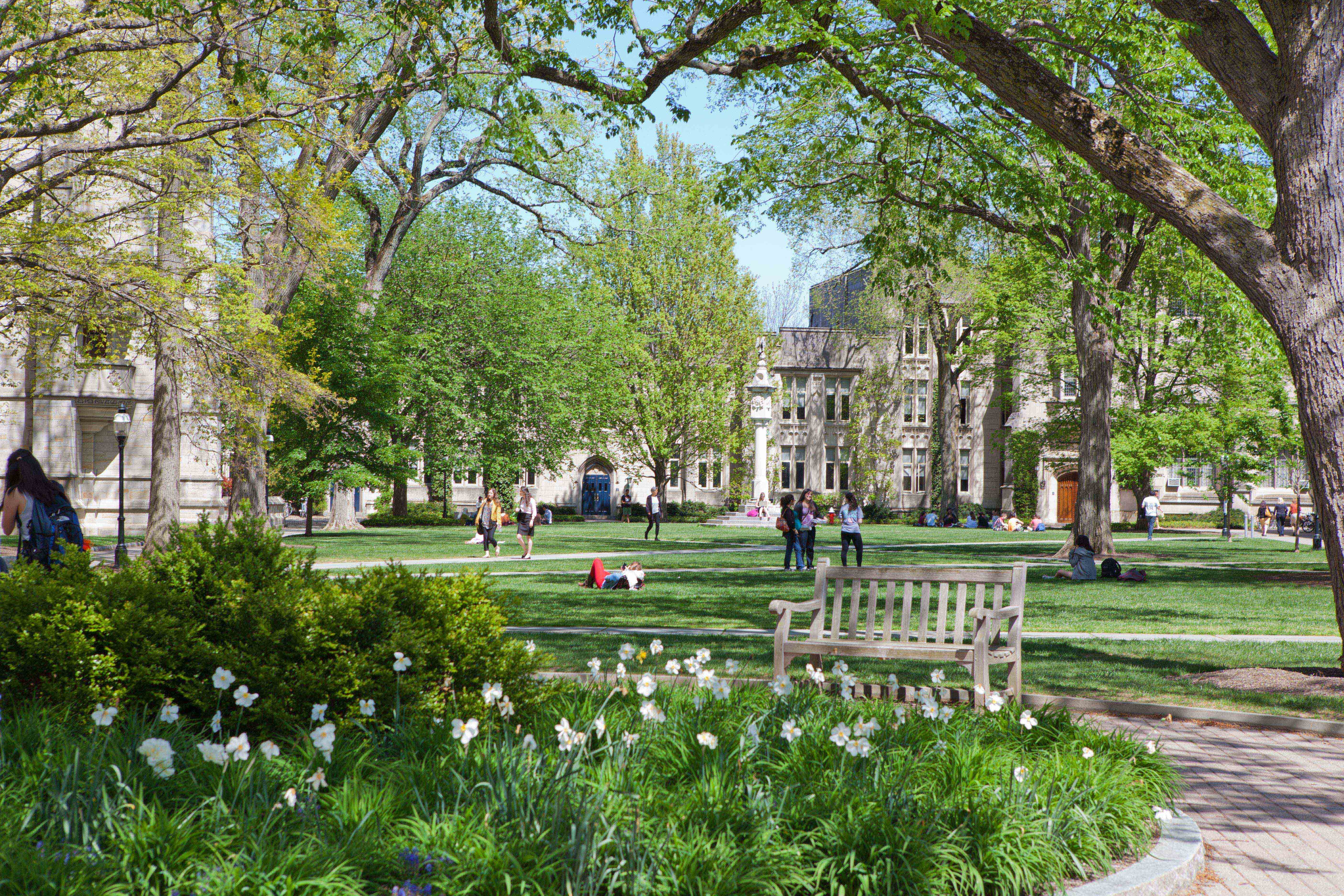 Princeton students walking and lounging during springtime at the McCosh courtyard on campus