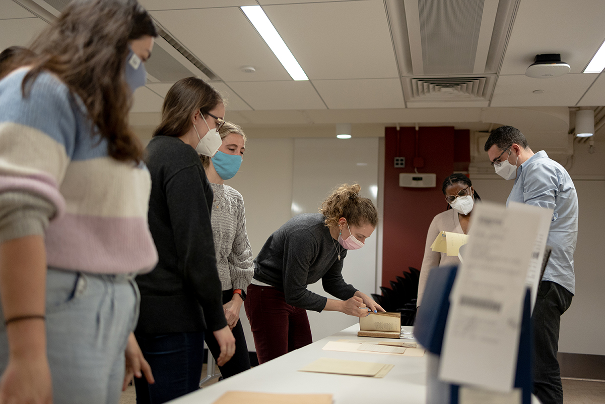 Grace Monk handles one of PUL’s Special Collections items in class