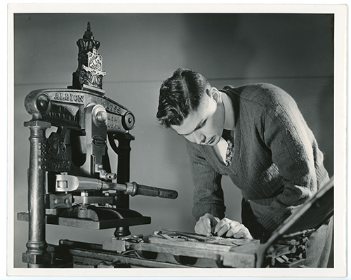 Photo of Gillett Griffin working with an Albion press