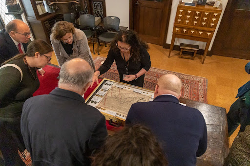 Elena Baldi shows conference goers a variety of coins in a display in the Scheide Library in PUL Special Collections.