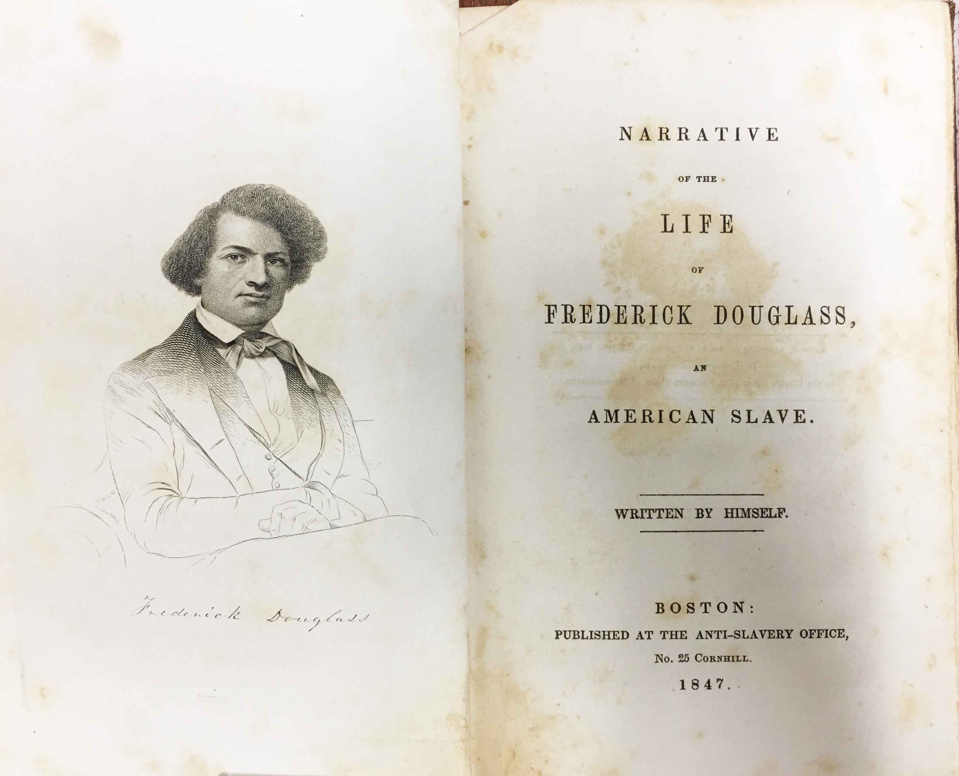 Copy of the book "Narrative of the Life of Frederick Douglass," open on a table to a portrait of Douglass and the title page