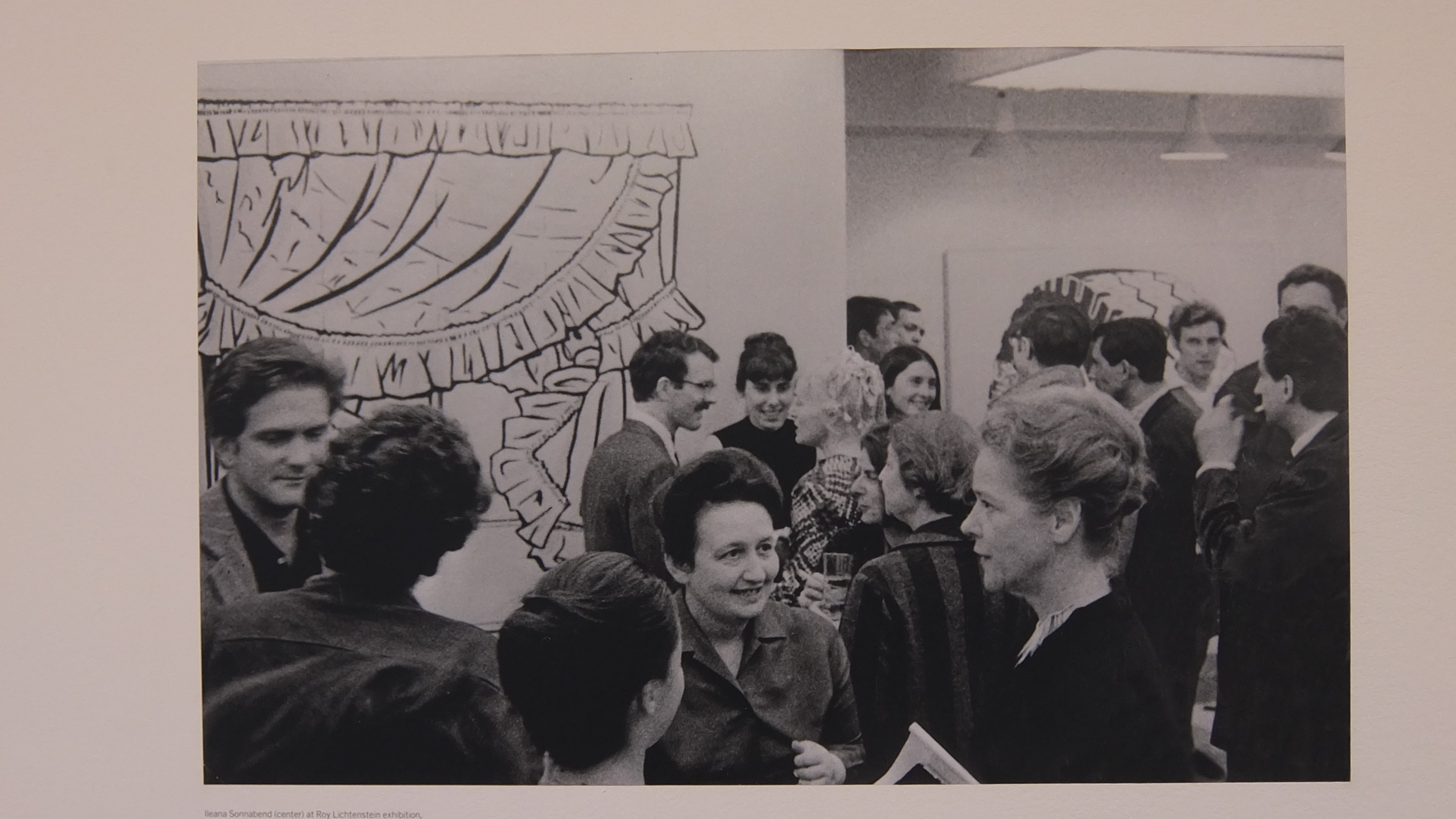 Black and white photo of people talking from Lichtenstein catalogue