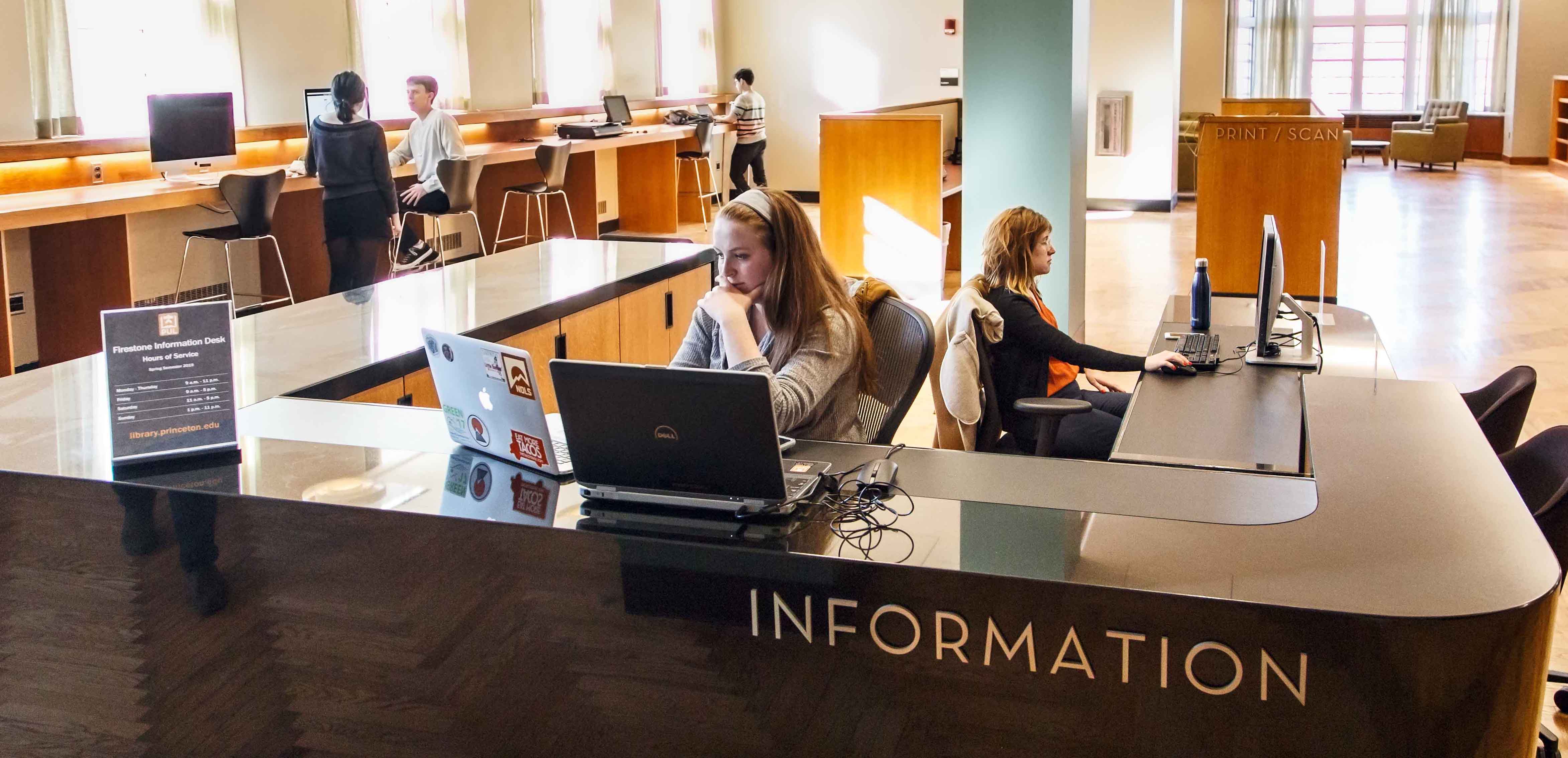 Student workers at the Information Desk in Firestone Library