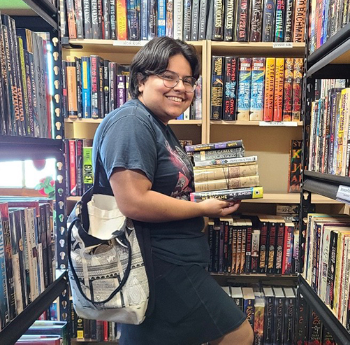 Stephanie Martinez holding a variety of books