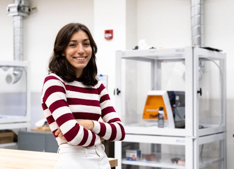 Caption: Eleni Retzepis in front of one of the PUL Makerspace’s 3D printers. Photo credit: Brandon Johnson