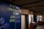 Gallery title wall "In the Company of Good Books" with wall image of Shakespeare and first folios in a display case