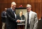 Bill Bradley '65 shakes hands with Dan Linke in front of his new portrait at Princeton University. 