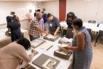 Kinohi Nishikawa and Jennifer Garcon helping Rare Book School attendees during their course on Black bibliography.