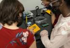 Princeton Students working with Makerspace Specialist Ariel Ackerly on soldering.