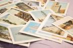 Collection of vintage travel postcards scattered on surface