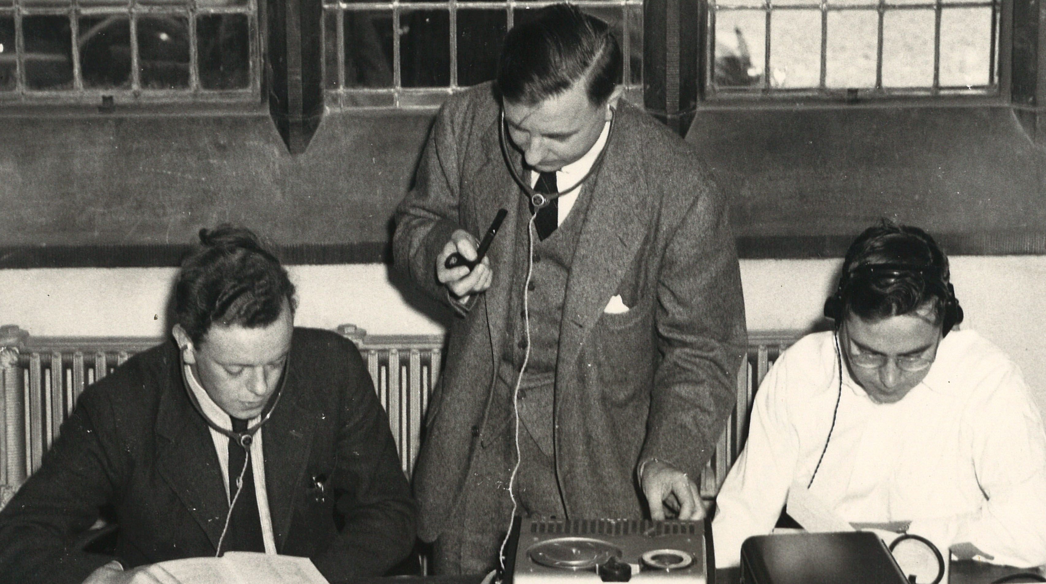 Three men looking at documents